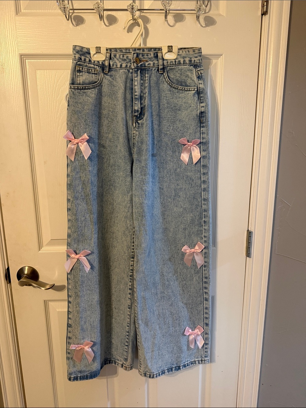 Light Wash Wide Leg Jeans with Pink Bow Accents